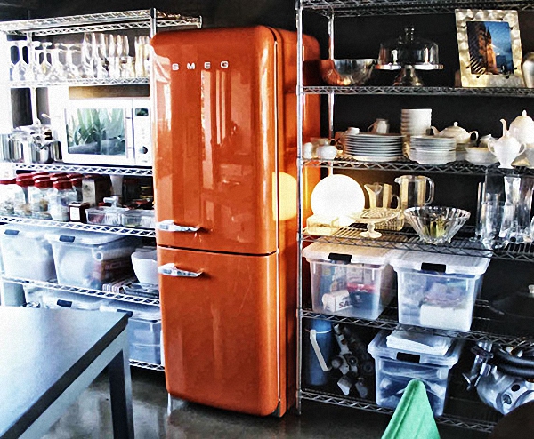 Холодильник SMEG оранжевого цвета в интерьере кухни-кладовой